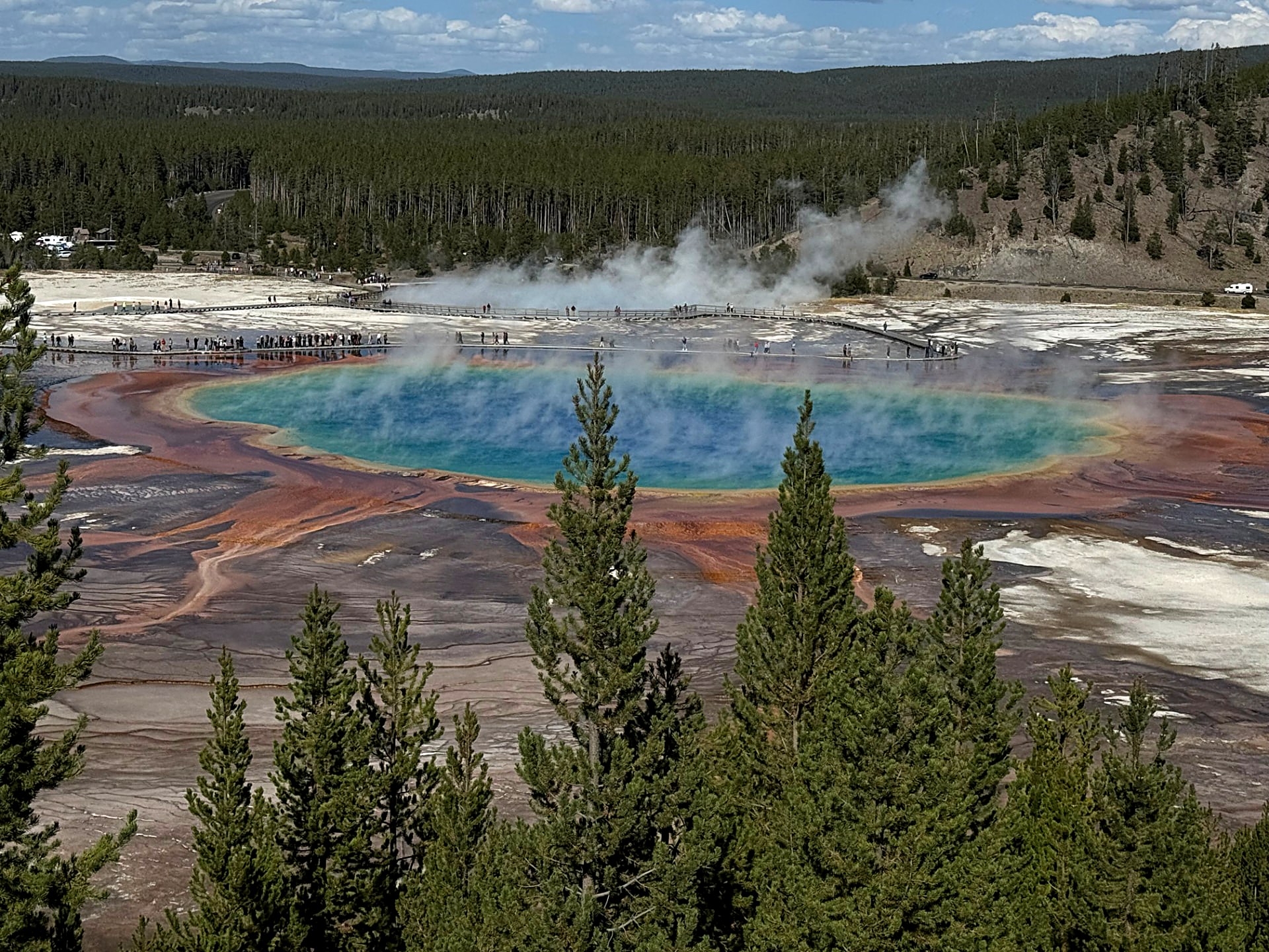 Grand Prismatic hot spring with blue center ringed by orange and rust
